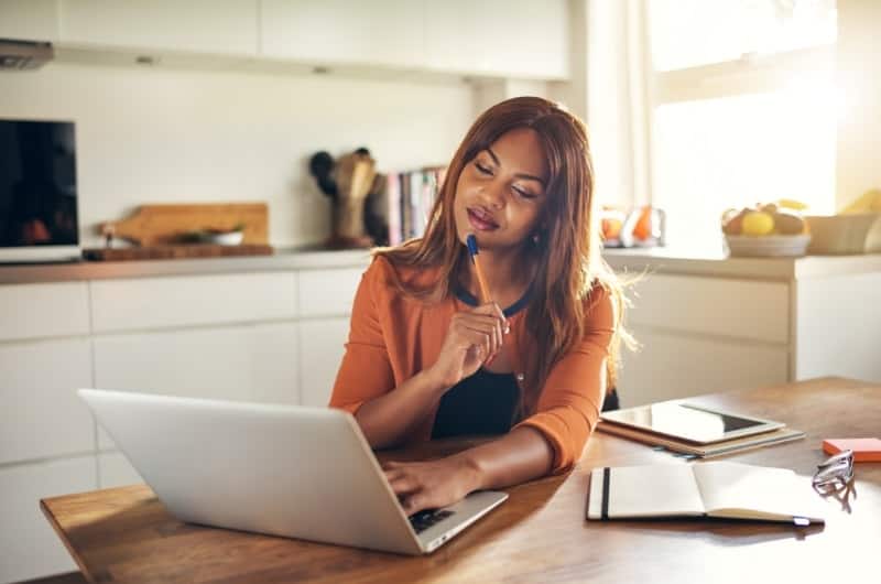 A young investor is reviewing her investing strategy to see if she should invest more of her money now, or hold and wait for a potential correction.