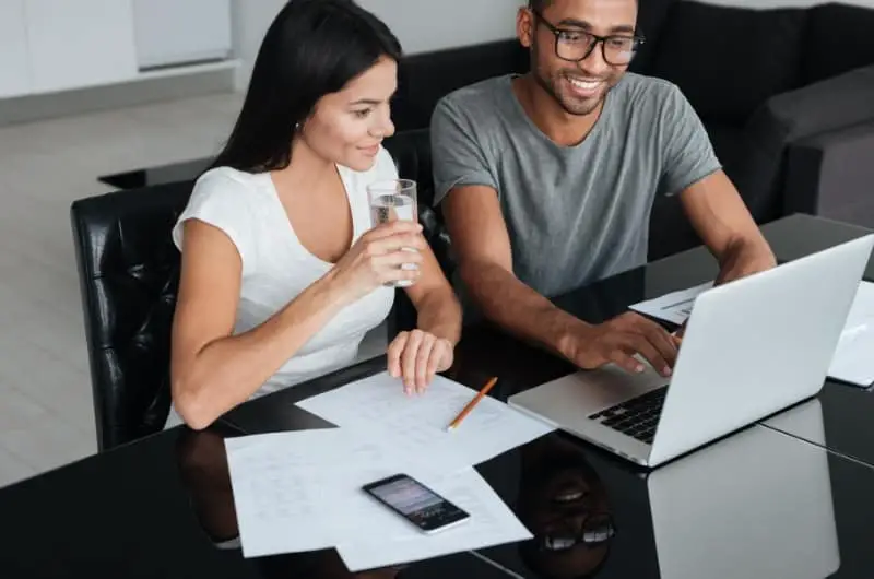 A young couple is reviewing their dollar-cost investing strategy together, and are happy with the upside results so far.