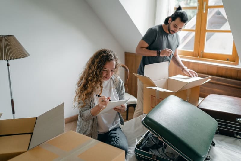 A young couple is unpacking after moving into their new home.