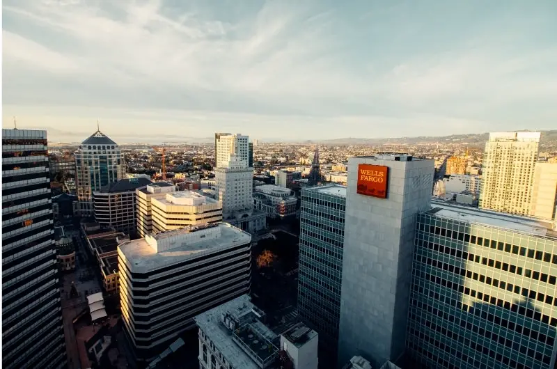 A visual of many large buildings in a big city. Buying REITs can help you profit from the leases on these large buildings and the many offices in them.