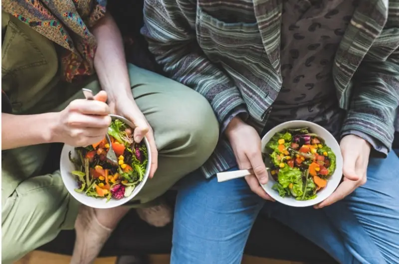 A young couple is eating at home to save money.