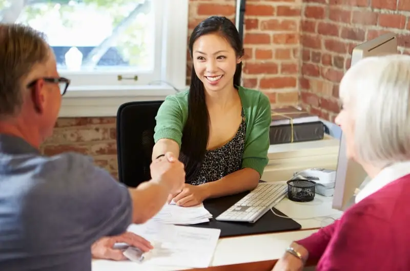 A financial advisor is helping an older couple with their money management and investing strategy.