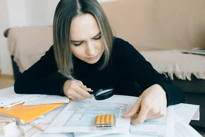 A young woman is reviewing the tax brackets to see what her total taxes would be on this years salary.