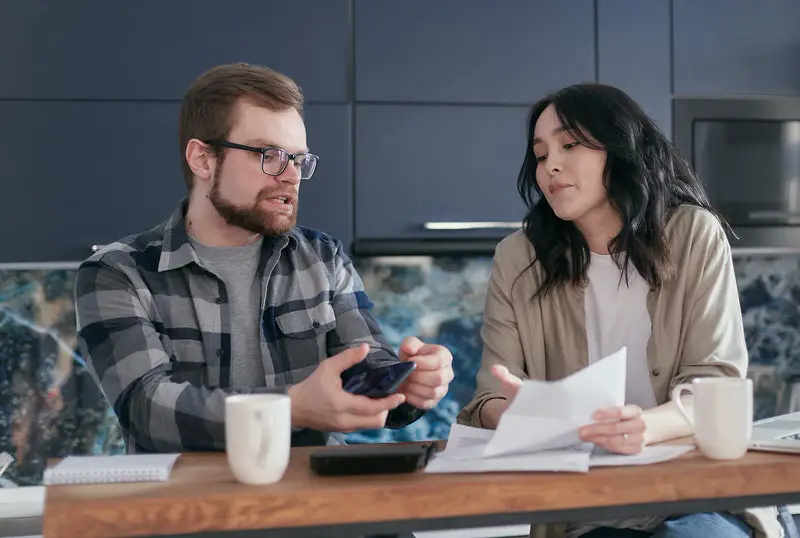 A husband is showing his wife their finances so that he can motivate her to work and become a dual-income household.