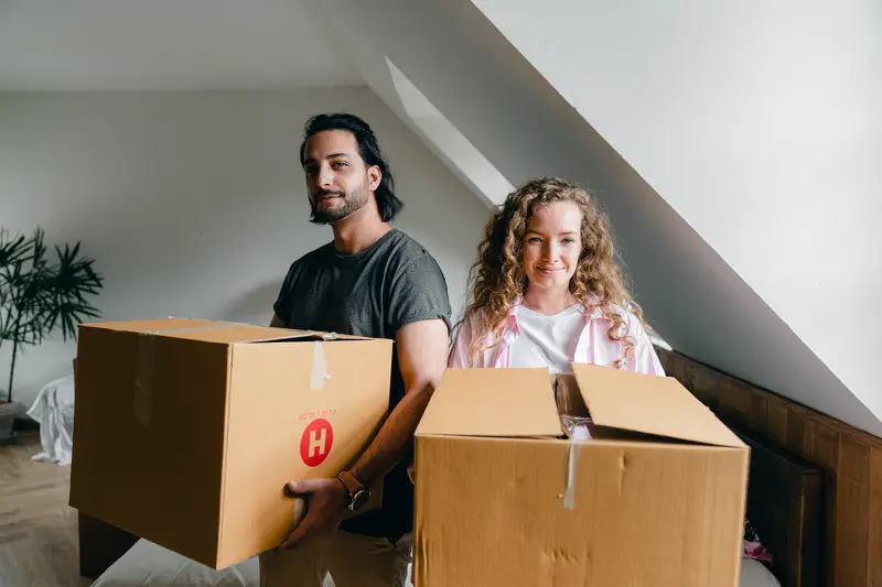 A couple is packing their belongings to move to another city for new opportunities.