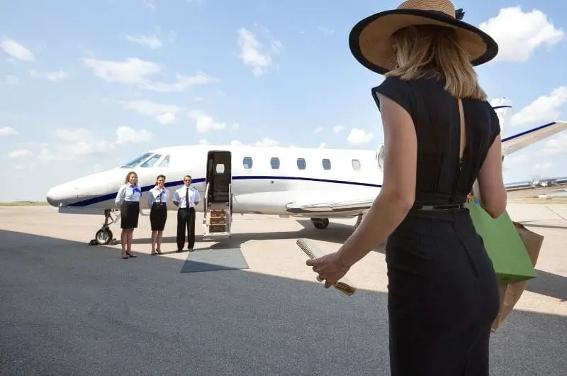 A woman is heading towards a private jet that she rented