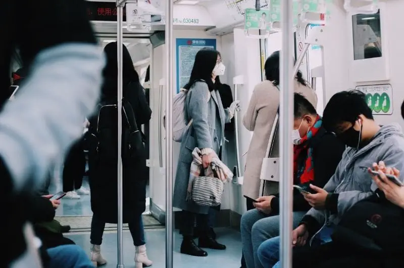 A group of commuters are in a train, heading to work