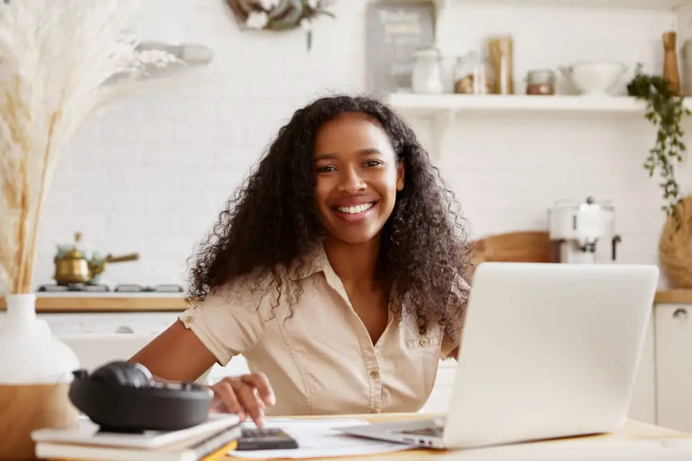 A young girl is working on her personal finance goals at her favorite cafe