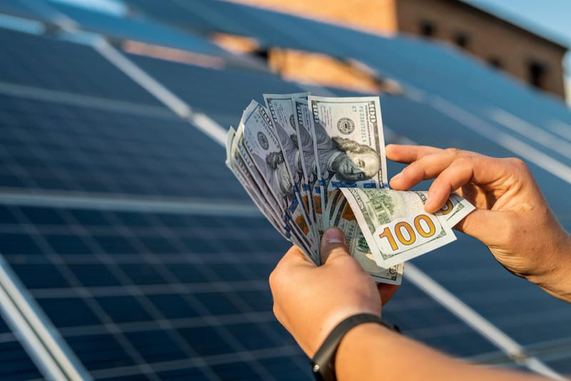 A man is making money from his solar panels because he's selling back excess energy to the utility company