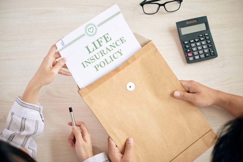 A couple is reviewing their life insurance policy documents