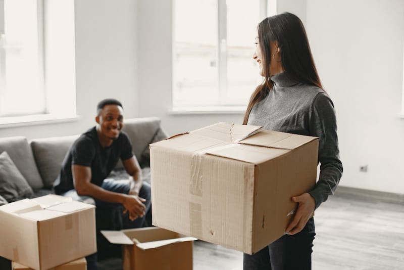 A young couple are packing to move out of their current apartment