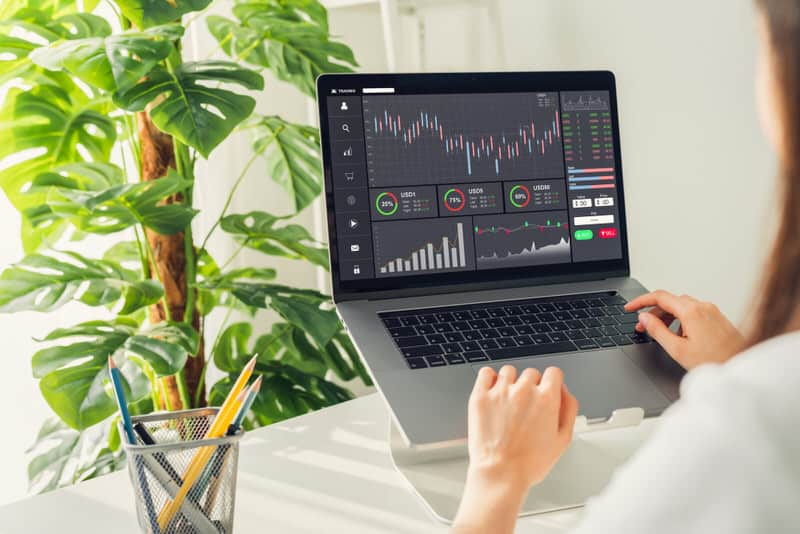 A young woman is on her computer trading with both her cash and margin investing accounts.