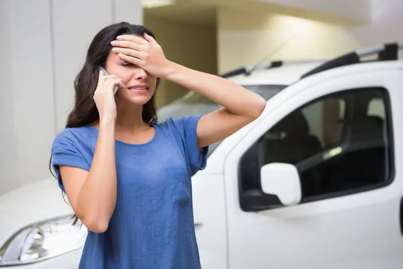 A young woman is upset after finding out that the car she is trying to trade in has negative equity