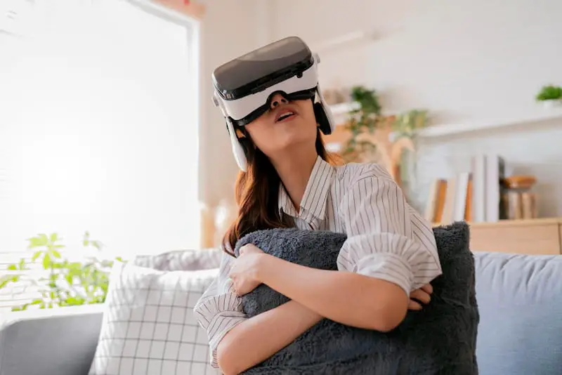 A young woman is attending a music concert on the metaverse by using her VR headset